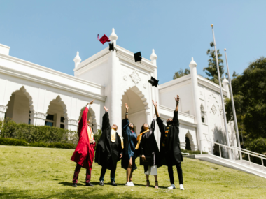 Students joyfully celebrating receiving scholarships at a university